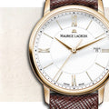 Maurice Lacroix Eliros Dameshorloge 30mm met witte wijzerplaat, goudkleurige kast en bruine leren band. Elegant Swiss Made dameshorloge.